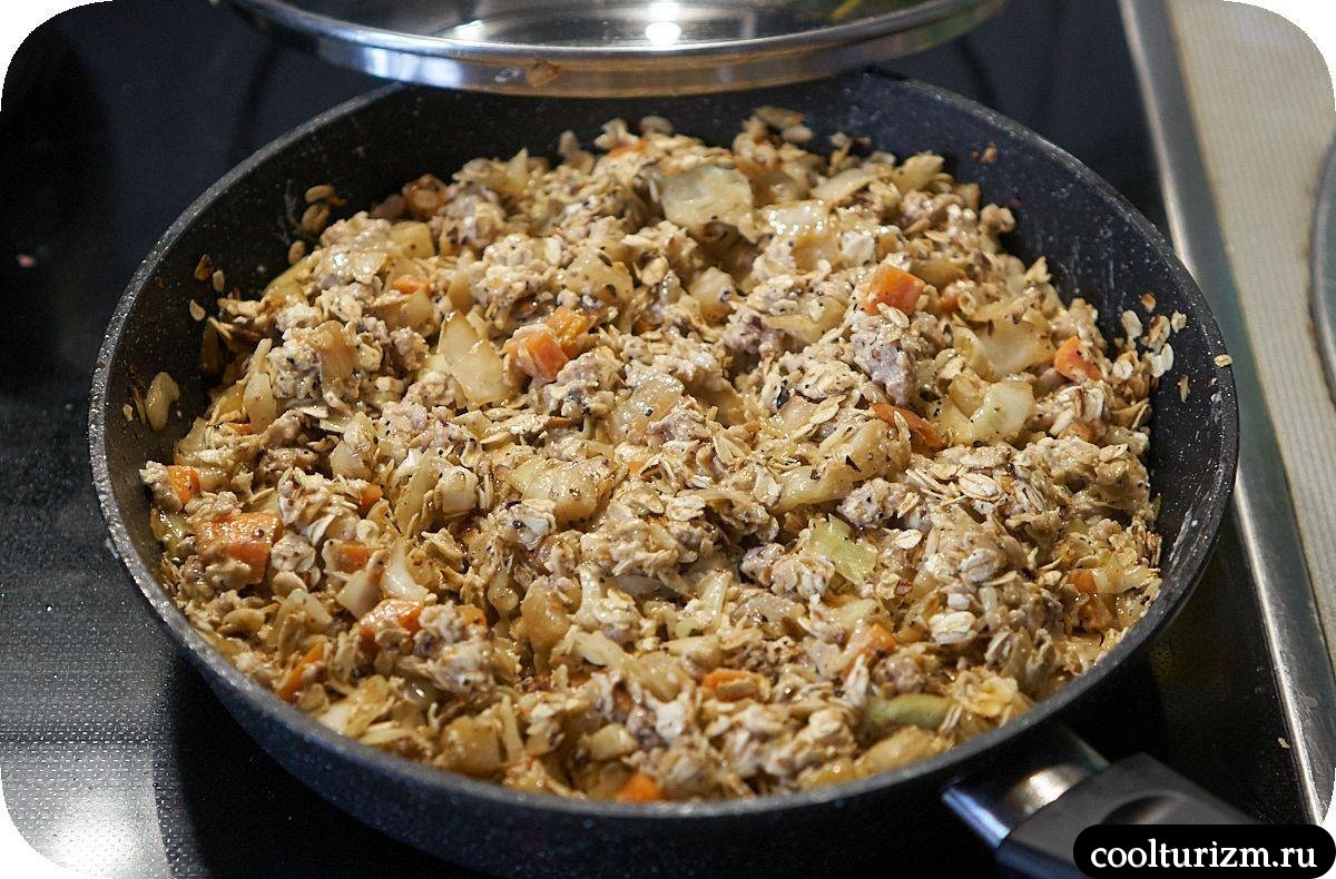 Жареная овсянка с фаршем и овощами на сковороде